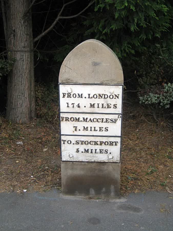 Milestone, London Road South: This grade II listed milestone has a lancet-shaped buff sandstone block (replaced late C20), supporting a cast-iron plaque circa 1824., close to the Aldi on London Road South, Poynton