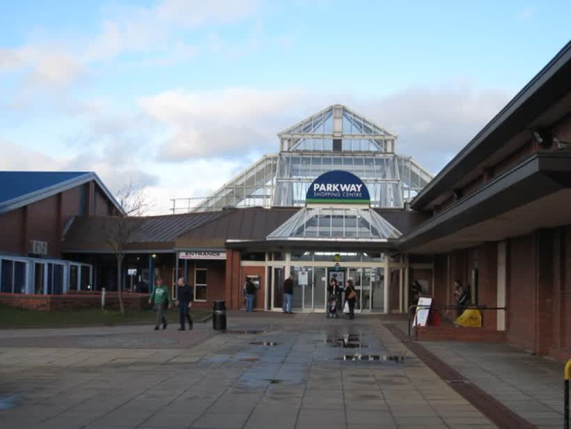 The Parkway Shopping Centre - Coulby Newham. This shopping centre provides a wide range of shops, cafes and restaurants for its visitors. Notice the distinctive glass-domed roof over the entrance hallway. The building to the left of the picture, the Rainbow Centre (see here 1596232), houses a library and sports complex - including a swimming pool., close to the Aldi on Dalby Way, Middlesbrough