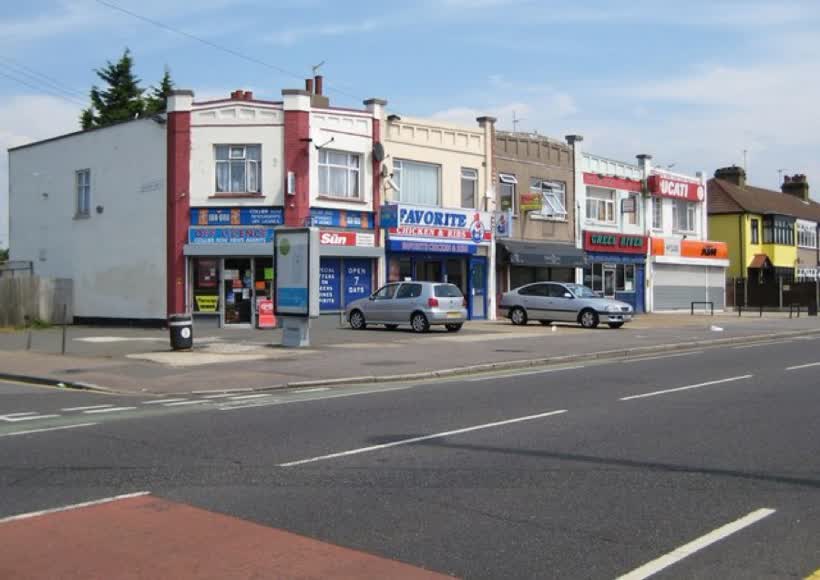Collier Row: Collier Row Road (2) This small parade of community shops, at the junction with Ramsden Road, dates from the 1920s/1930s and has an unusual roof parapet. The history of previous occupiers of these types of shops is always interesting, so for the record the following occupiers were present, from left to right, in July 2008:- Collier Row Newsagents Favorite Chicken & Ribs Hairzone Green River Chinese takeaway Hyside Motorcycles, close to the Aldi on Collier Row Road, Romford