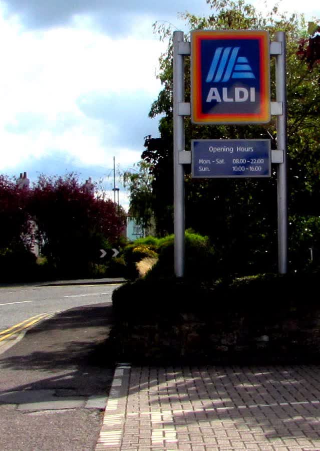 Aldi name sign and opening hours, Quaker Lane, Thornbury, close to the Aldi on Horseshoe Lane, Thornbury